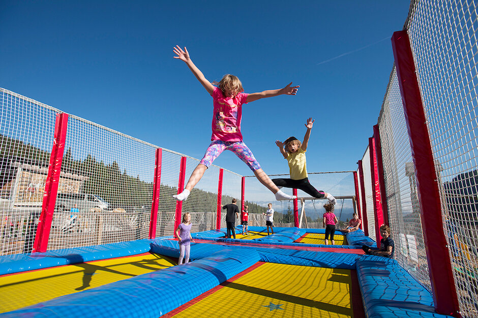 Kinder springen am Riesentrampolin